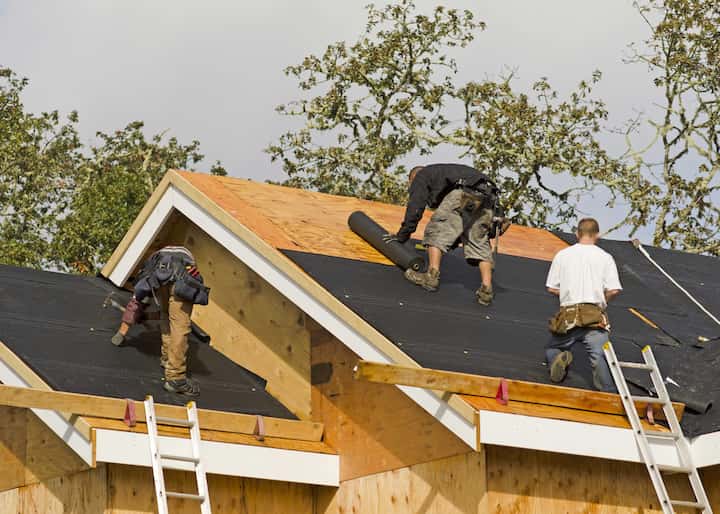 Professional roofers in Naperville, Illinois working on roofing repair for new build of home